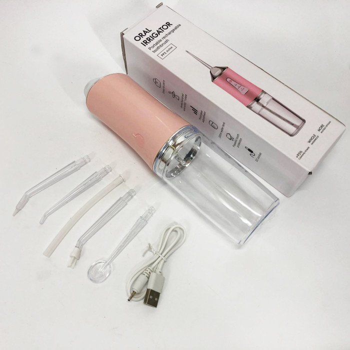 Іригатор для чищення зубів та порожнини рота Oral Irrigator з акумулятором та змінними насадками. Колір: рожевий