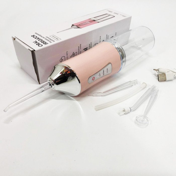 Іригатор для чищення зубів та порожнини рота Oral Irrigator з акумулятором та змінними насадками. Колір: рожевий