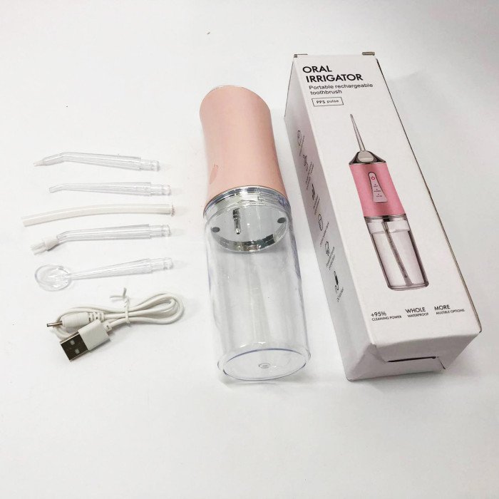 Іригатор для чищення зубів та порожнини рота Oral Irrigator з акумулятором та змінними насадками. Колір: рожевий