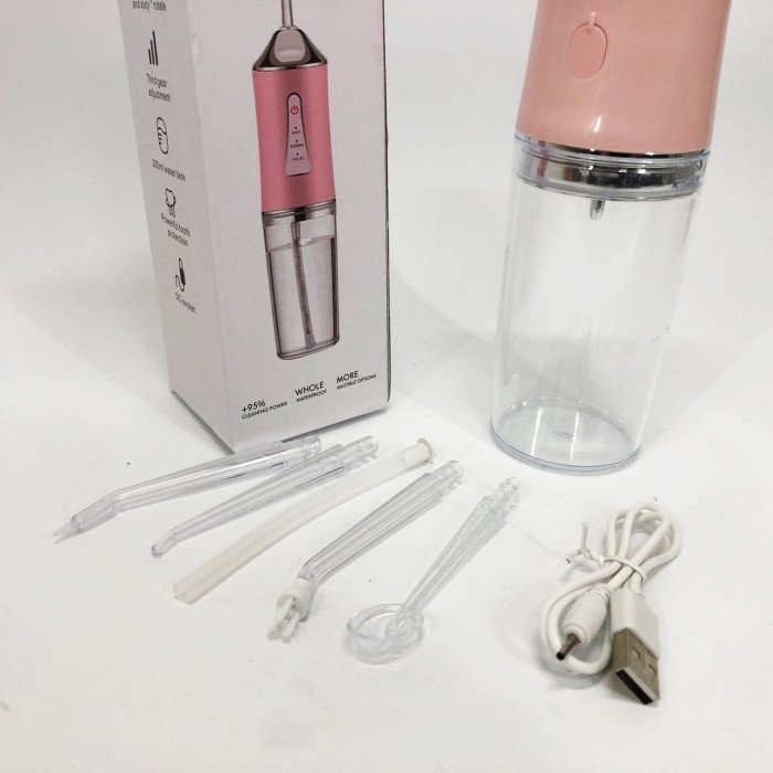 Іригатор для чищення зубів та порожнини рота Oral Irrigator з акумулятором та змінними насадками. Колір: рожевий