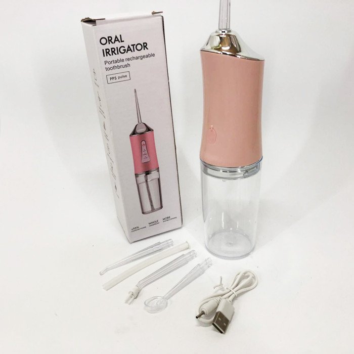 Іригатор для чищення зубів та порожнини рота Oral Irrigator з акумулятором та змінними насадками. Колір: рожевий